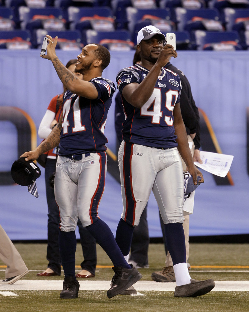 Media Day at the Super Bowl is always a spectacle as two of the Patriots, Malcolm Williams, left, and Markell Carter share in the festivities by taking their pictures to show they were at the Super Bowl.