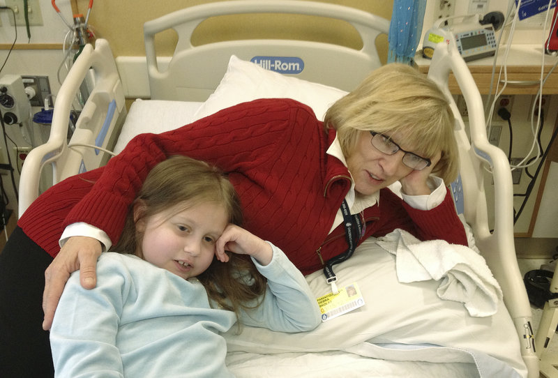 Alannah Shevenell of Hollis rests with grandmother Debi Skolas in her hospital bed at Children’s Hospital Boston on Tuesday. Skolas said she is grateful for and overwhelmed by the medical staff’s skill and support during the 9-year-old’s ordeal. “I love them,” Skolas said. “I don’t think there’s another place in the world that could have pulled this off.”