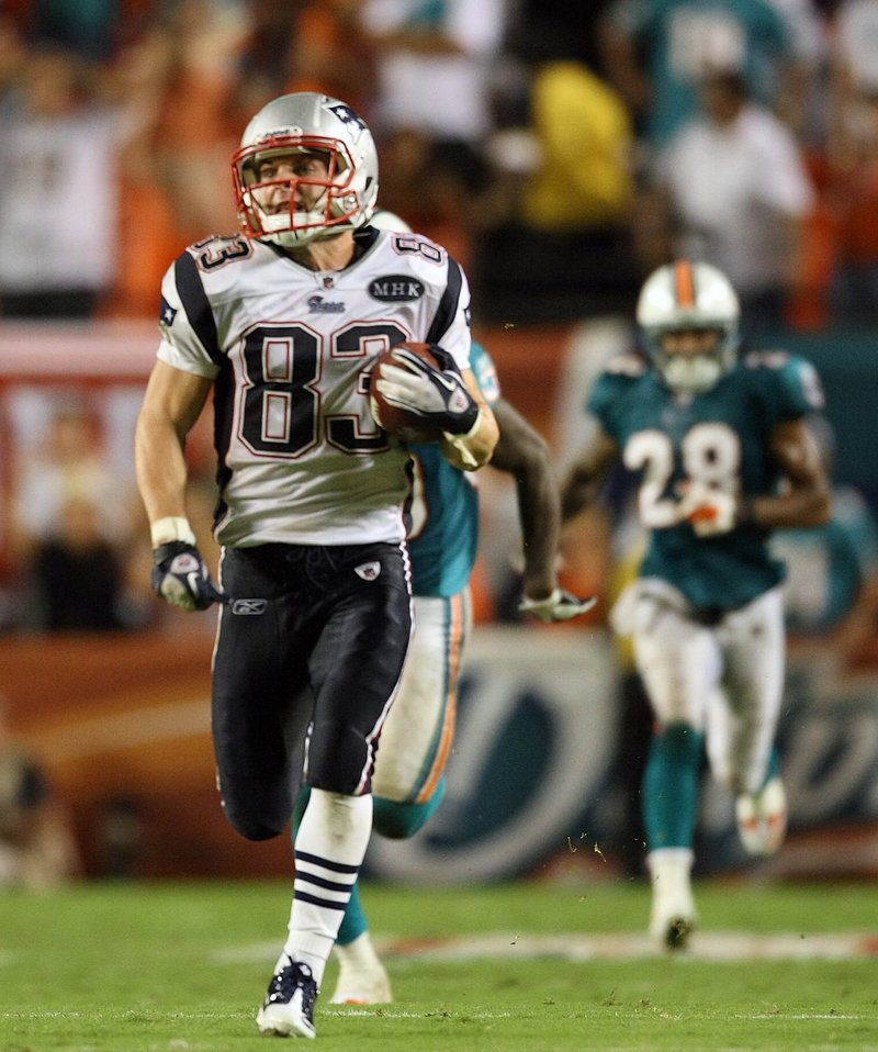 Wes Welker heads for the end zone to complete a 99-yard pass play in the Patriots’ opener, a 38-24 win against the Dolphins on Sept. 12.