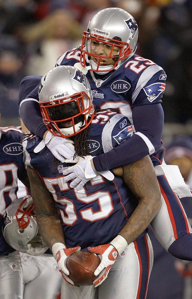 Sterling Moore, top, and Brandon Spikes made key defensive plays as the Patriots barely beat the Ravens 23-20 in the AFC championship game on Jan. 22.