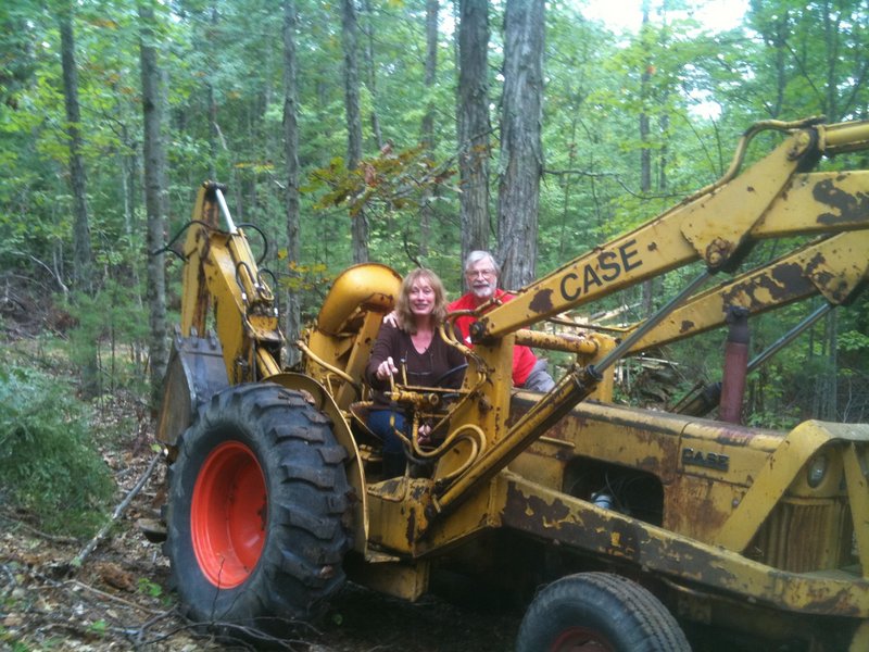 Gayle Lynds and John C. Sheldon in their backhoe.