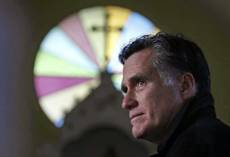 Former Massachusetts Gov. Mitt Romney pauses during a visit to St. Paul’s Lutheran Church while campaigning in a Berlin, N.H., neighborhood in December. Romney could become the first Mormon presidential nominee of a major political party.