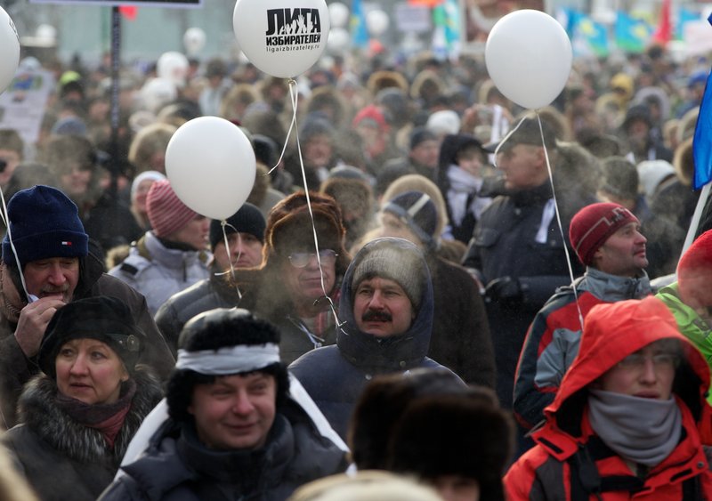 Demonstrators endure bitterly cold temperatures as they march during a massive protest against Prime Minister Vladimir Putin’s rule in Moscow on Saturday.