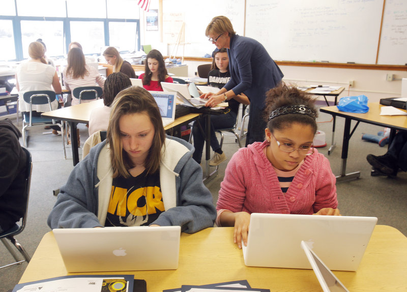 Jessy Brewer, left, and Kiara Neal work on their laptops in Ann Young’s math class at King Middle School. Portland expects to receive 6 percent more state school aid in 2013.