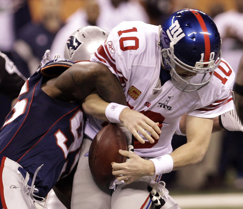 Mark Anderson of the Patriots sacks Eli Manning, ending a promising opening drive for the Giants.
