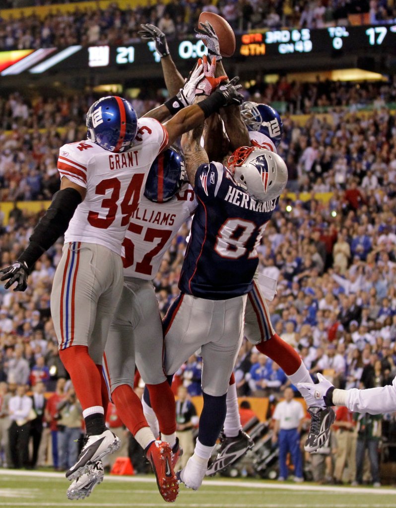 Patriots tight end Aaron Hernandez goes up against three Giants defenders in an unsuccessful attempt to catch Tom Brady’s desperation heave into the end zone on the final play of the Super Bowl.