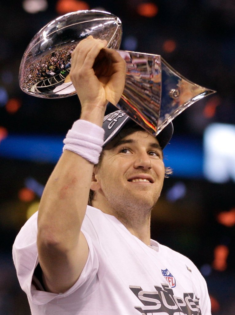Giants quarterback Eli Manning holds up the Vince Lombardi Trophy given to the Super Bowl champions.