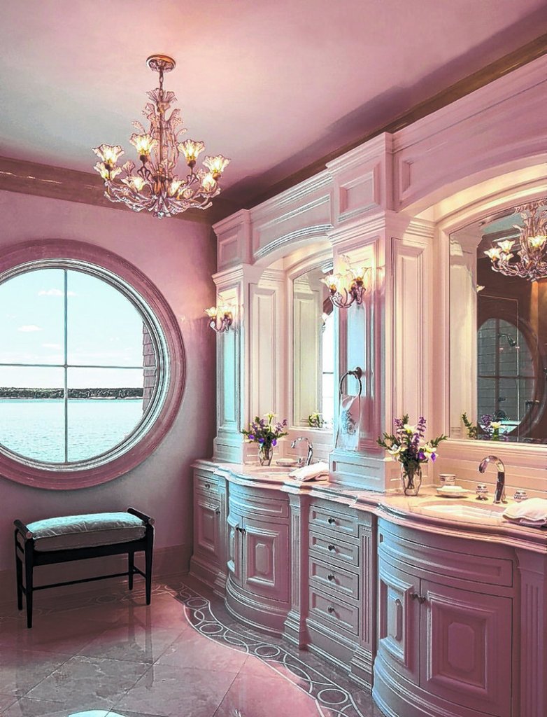 In this master bath, a TV hides behind one of the mirrors in the vanity.