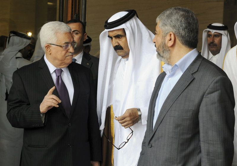 Palestinian President Mahmoud Abbas, left, and Khaled Mashal, chief of the Islamic militant group Hamas, right, confer with Qatar’s crown prince Sheik Tamim Bin Hamad Al Thani during a meeting in Doha, Qatar, on Monday.