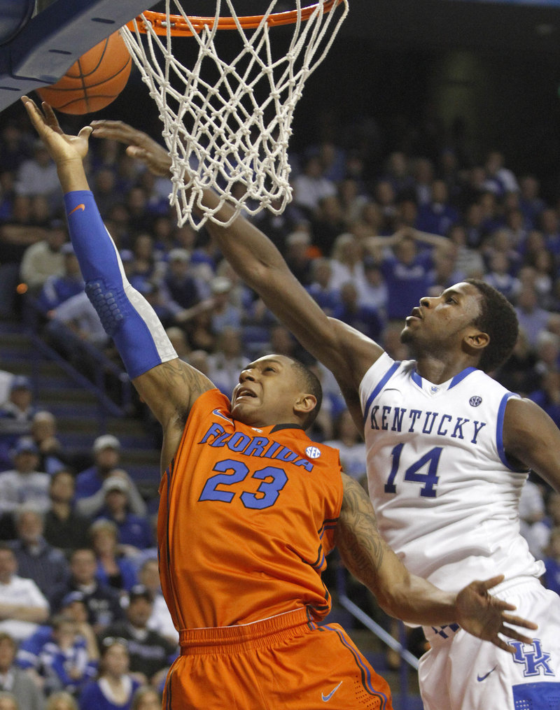 Bradley Beal of Florida is pressured by Kentucky’s Michael Kidd-Gilchrist in Tuesday night’s game at Lexington, Ky. Top-ranked Kentucky won, 78-58.