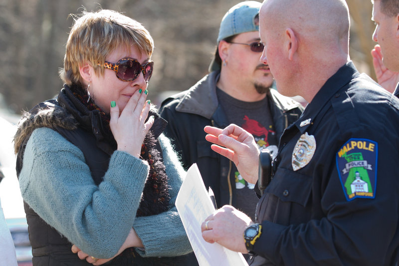 A parent of a Walpole Elementary School student speaks to police outside the school, where a 14-year-old boy shot himself in front of many classmates in the school’s cafeteria.