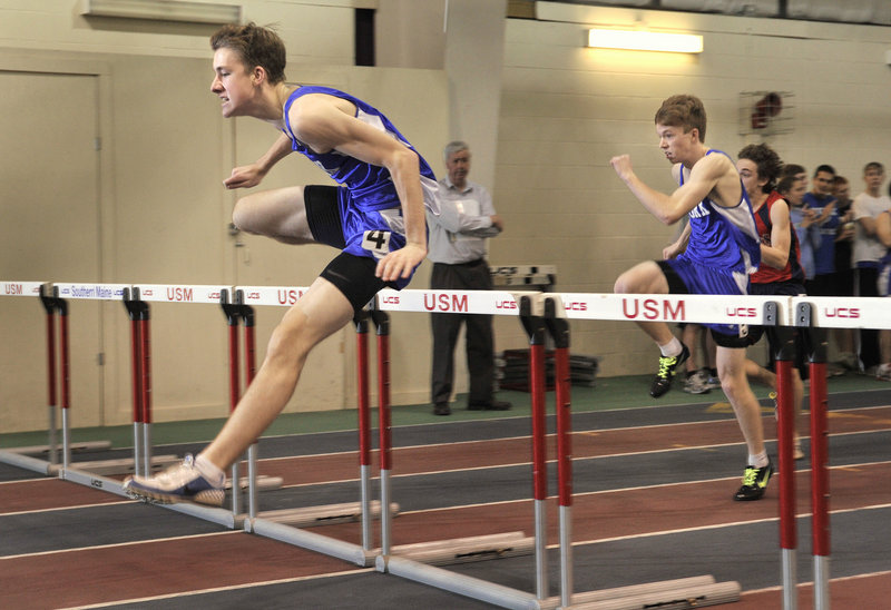Tom Reid of York clears the final hurdle on his way to a second-place finish in the 55-meter hurdles. Reid also won the triple jump and placed second in the long jump.