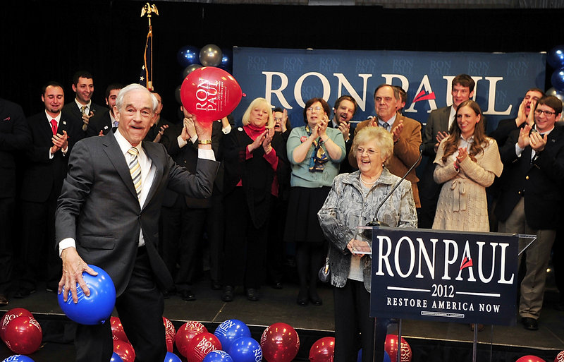 Republican presidential candidate Ron Paul tosses balloons to supporters Saturday night at the Seasons Event and Conference Center in Portland. His supporters and the Paul campaign say the cancellation of a local caucus meeting in Washington County robbed Paul of a victory over Mitt Romney.