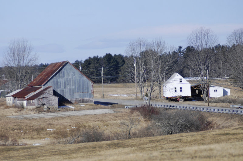 The Lunt farmhouse, right, sits along Route 111 in Arundel before the move Sunday. The historical society is in the midst of raising money to place the farmhouses on new foundations.