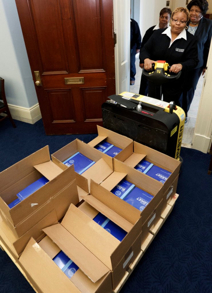 Copies of President Obama’s fiscal 2013 federal budget arrive Monday at the House Budget Committee room on Capitol Hill. The proposal claims that it includes $4 trillion in deficit savings over the coming decade.