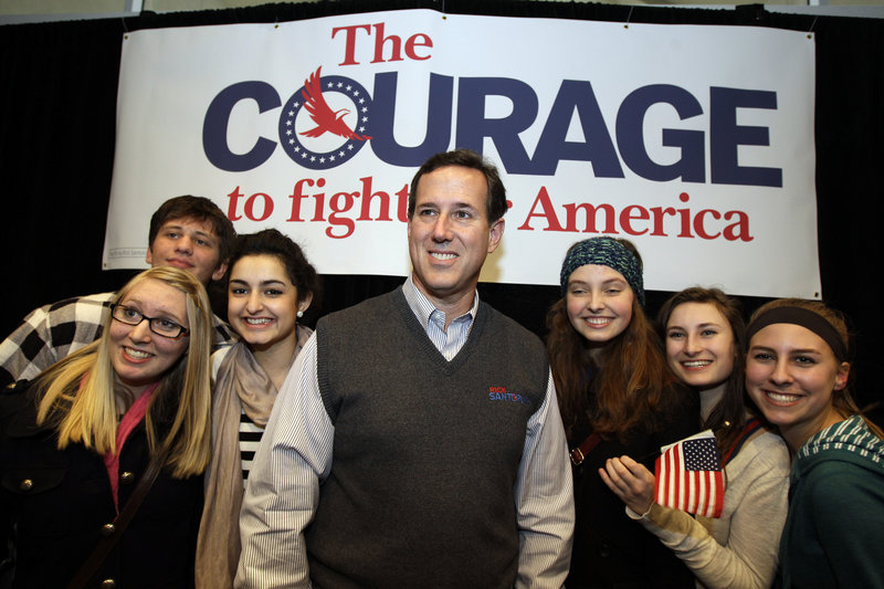 Republican presidential candidate Rick Santorum poses for a photo with supporters after speaking at a rally Tuesday in Coeur d’Alene, Idaho.