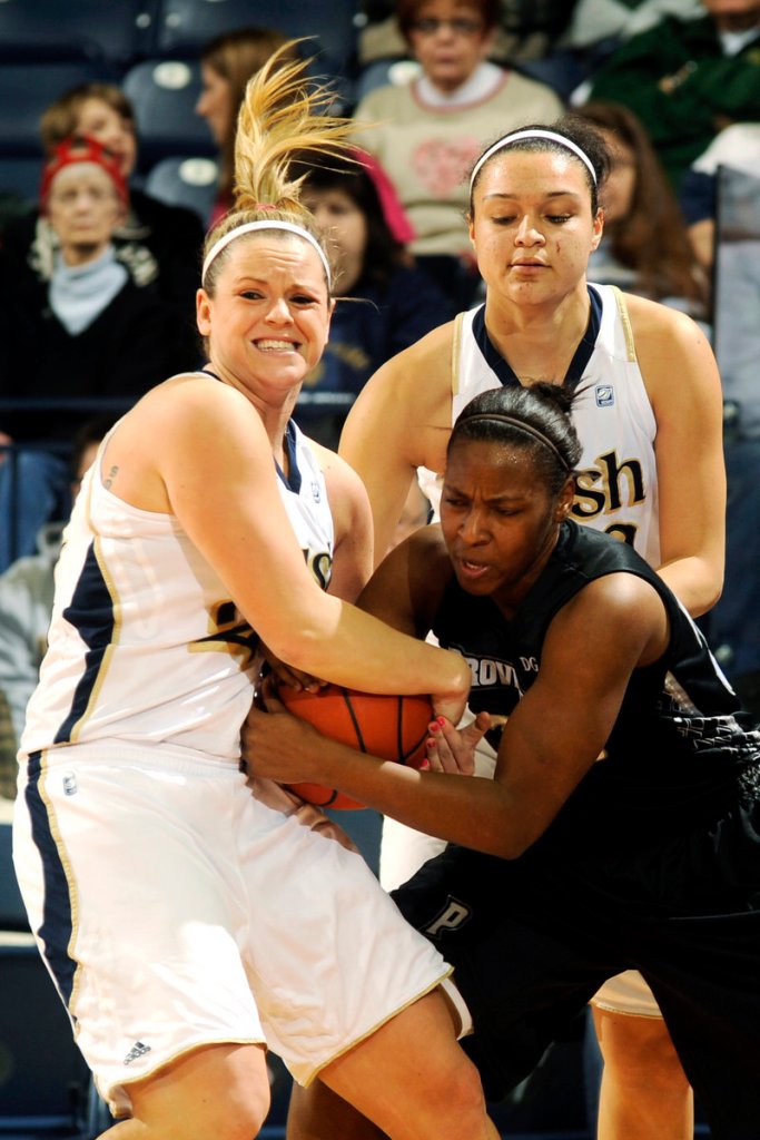 Notre Dame’s Brittany Mallory, left, and Kayla McBride battle with Providence’s Rachel Barnes for a loose ball in Tuesday’s game. Host Notre Dame won, 66-47.