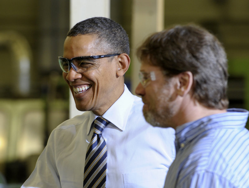 President Barack Obama tours a factory earlier this month. The president has proposed a plan to significantly lower the tax rate on American corporations. (AP Photo / Susan Walsh)