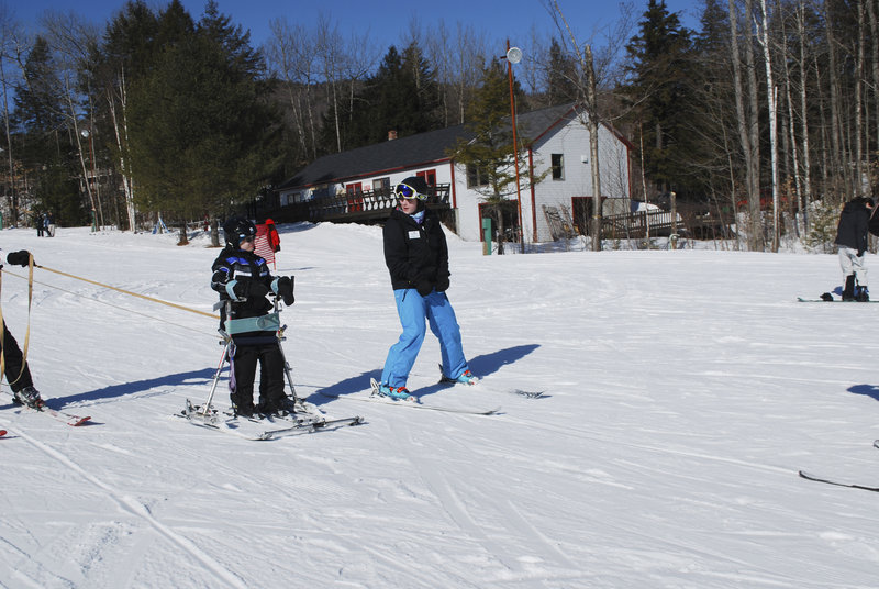 Max Thorman of Crescent Park Elementary School receives instruction from Margaret Adams, a Gould Academy senior and a ski coach in the Rugrats program.