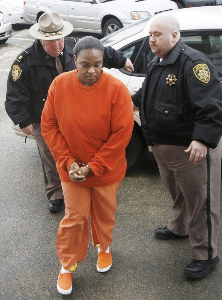 Darlene George, 43, of Old Orchard Beach is led into York County Superior Court during her trial on charges that she and her brother murdered her husband in 2008.