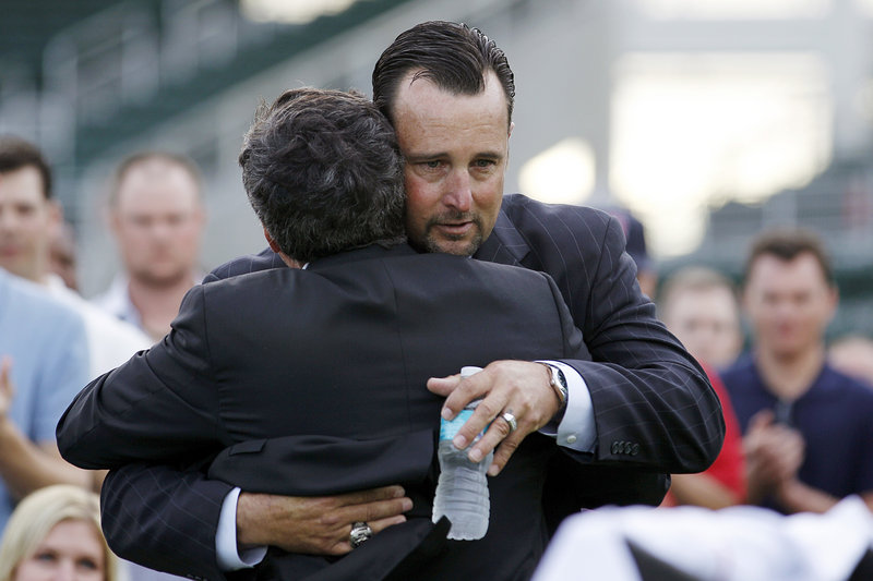 Tim Wakefield embraces Tom Werner, the Red Sox chairman, before announcing his retirement.