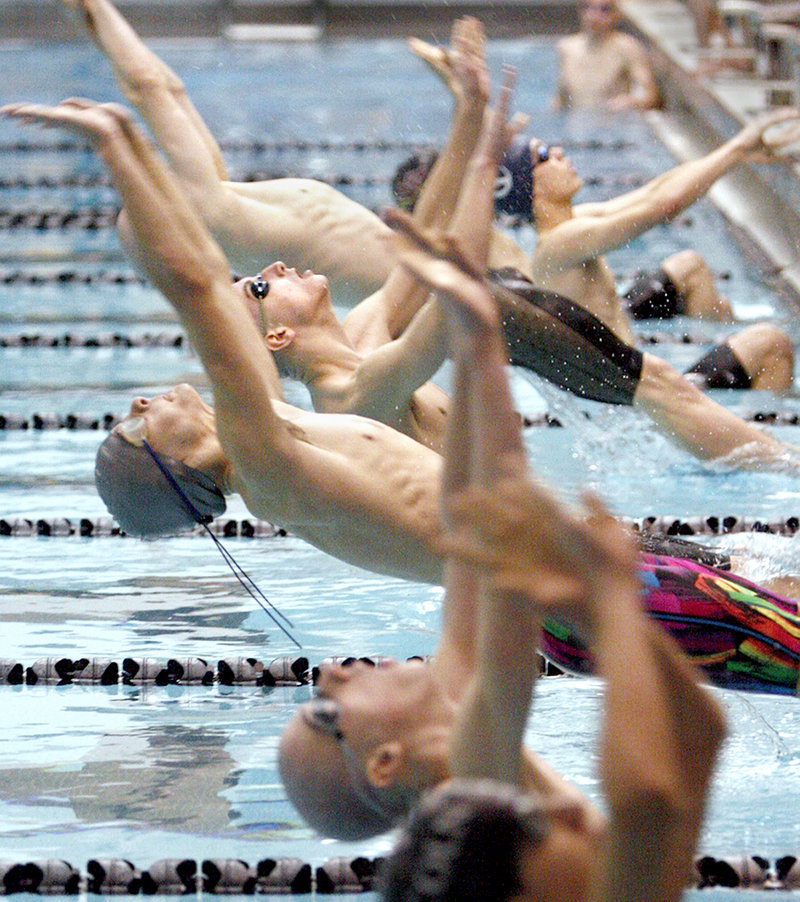 Jack Benoit of Greely launches into the water at the start of a 200-yard medley relay preliminary during the Class B state championships. Greely won the night race and the title.