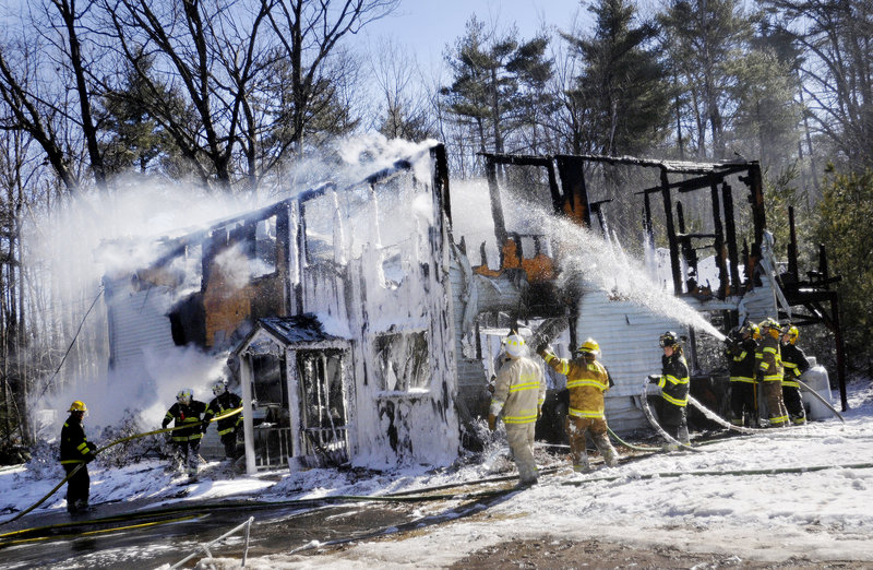 Firefighters put out a blaze at a two-story home at 82 Shaving Hill Road in Limington on Monday. Firefighters from 10 towns responded to extinguish the fast-moving fire.