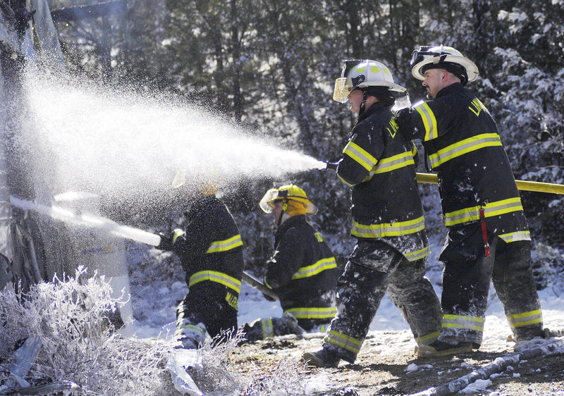 Firefighters use bog water to extinguish a fast-moving blaze in Limington in 2014.
