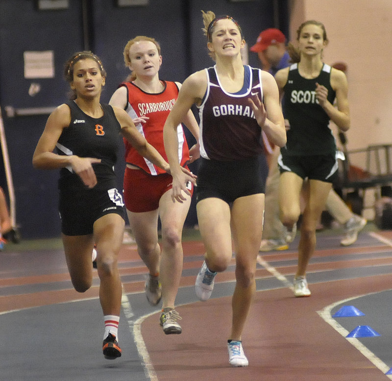 Sarah Perkins, right, of Gorham battles with Brewer’s Teal Jackson, left, and Scarborough’s Emily Tolman in the 400-meter dash Monday at the Class A state meet. Perkins took first, Jackson second and Tolman third.