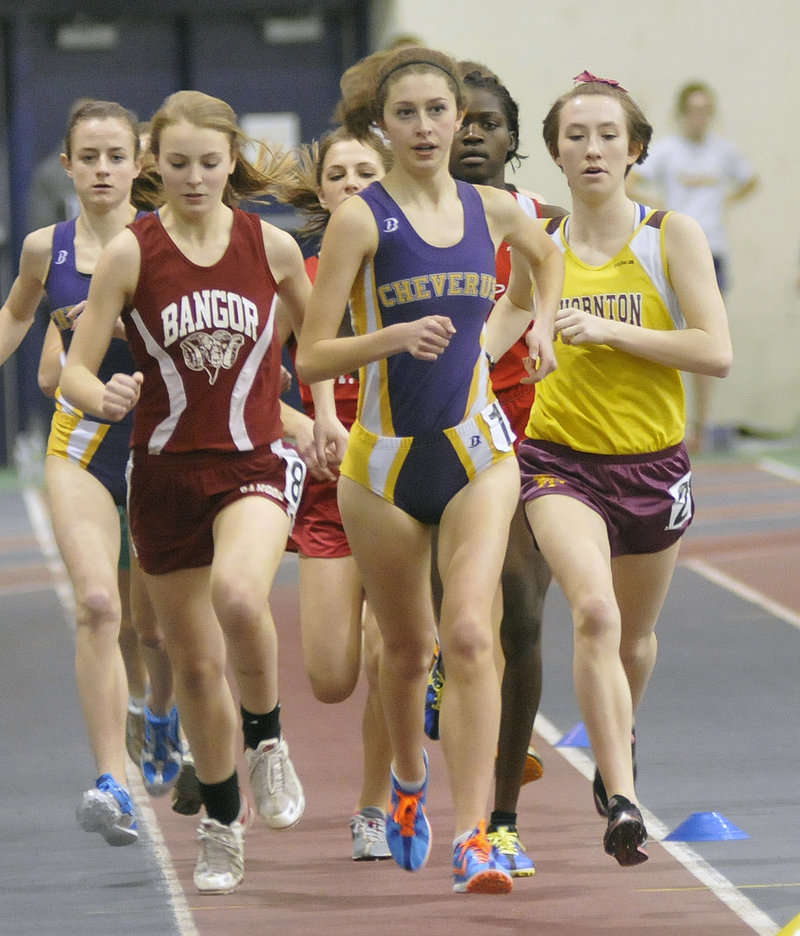 Fiona Hendry, center, of Cheverus leads in the mile with Bangor’s Angelyn Masters and Thornton Academy’s Charlotte Pierce at her side at the Class A state meet. Hendry won the event in 5:16.20.
