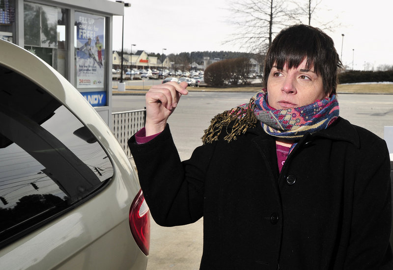 Penny Snow of South Portland fills her minivan with gas at $3.75 per gallon in Falmouth on Tuesday. Her husband, who commutes 50 miles each way to Kittery in a Ford Taurus, is thinking of getting an electric car.