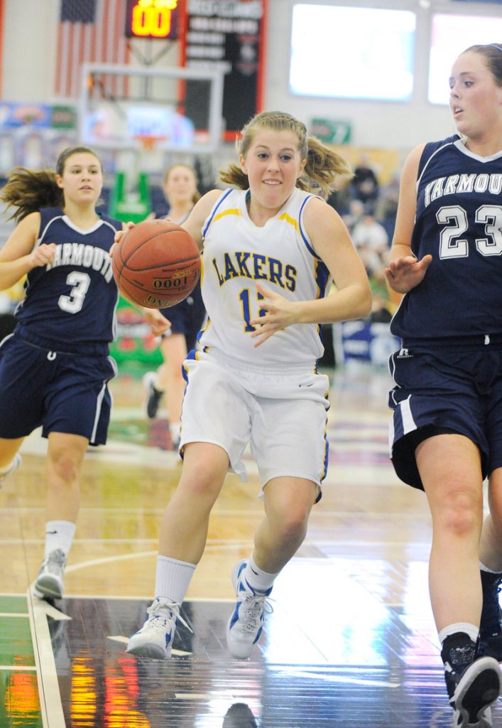 Sarah Hancock of Lake Region takes the ball to the basket on a fast break against Morgan Cahill of Yarmouth. Lake Region won, 60-34.