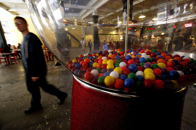A giant gum ball machine stands in the back of Grand Central Market in Los Angeles. As sales of gum balls have declined, many of the old-time machines dispense toys.