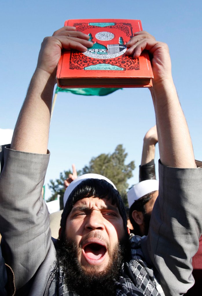 An Afghan protester holds a copy of the Quran and yells slogans during an anti-U.S. demonstration in Jalalabad.