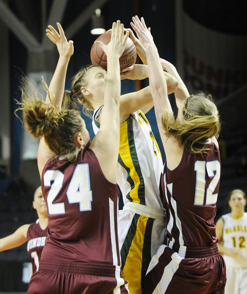 Olivia Smith of McAuley attempts to get the ball to the basket while defended by Diandra Berthiaume, left, and Sam Frost of Windham.