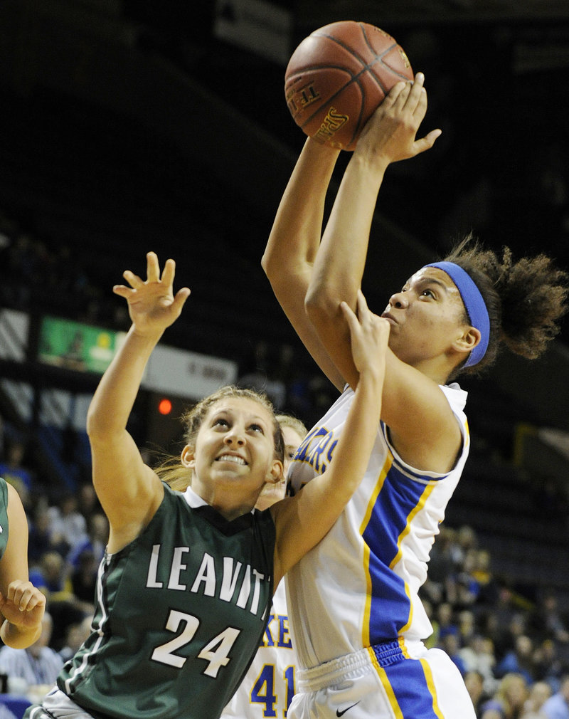 Tiana-Jo Carter, who finished with 25 rebounds for Lake Region, hauls down the ball over Kelly Pomerleau of Leavitt during the Lakers’ 59-54 overtime victory at the Cumberland County Civic Center.