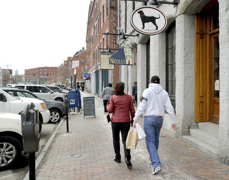 Businesses on Commercial Street in Portland draw shoppers on Friday. A commercial real estate survey shows the area along the waterfront has the lowest vacancy rate in the city.