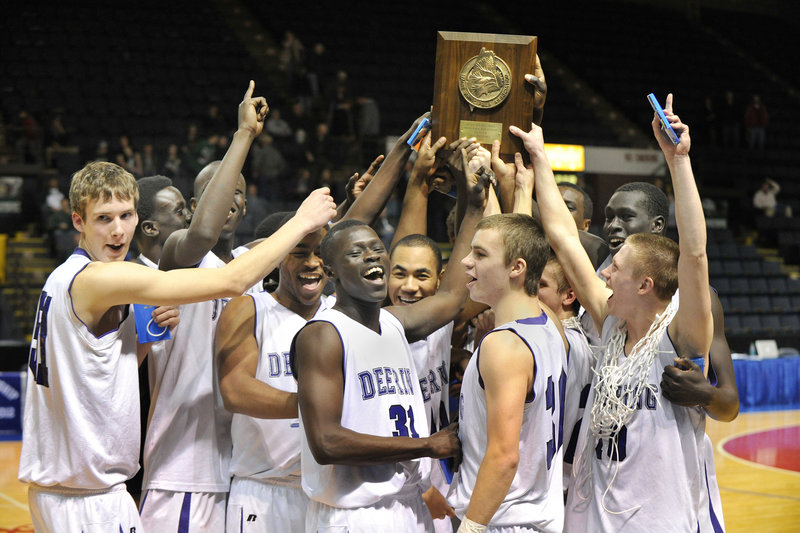 Deering players hold up their regional championship trophy after their dramatic victory over Bonny Eagle. The Rams will play Hampden Academy in the state final at 7 p.m. Saturday in Portland.