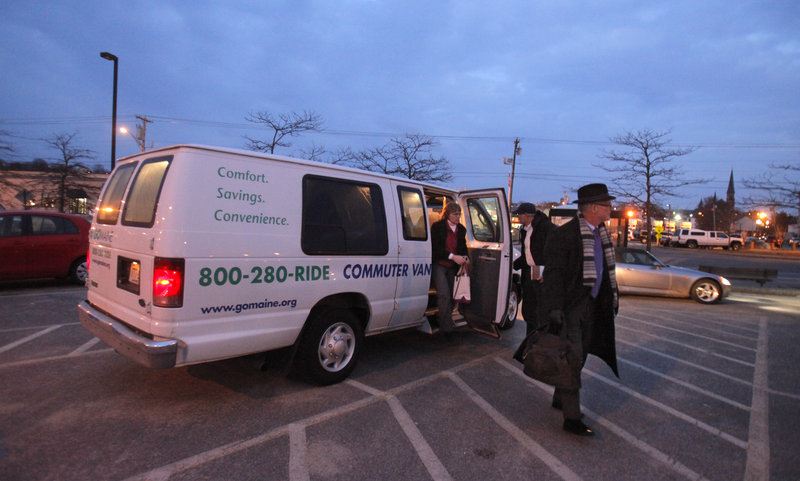 Commuters exit a van Monday at the park-and-ride lot on Marginal Way in Portland. The state is suspending the service, which has been run by Go Maine for the past 10 years.