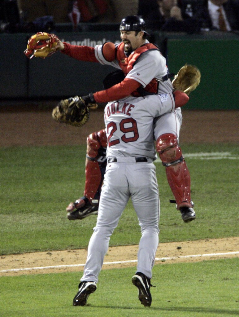 The Curse is over … Red Sox catcher Jason Varitek leaps into the arms of closer Keith Foulke after Boston swept St. Louis in the 2004 World Series to end an 86-year championship drought.