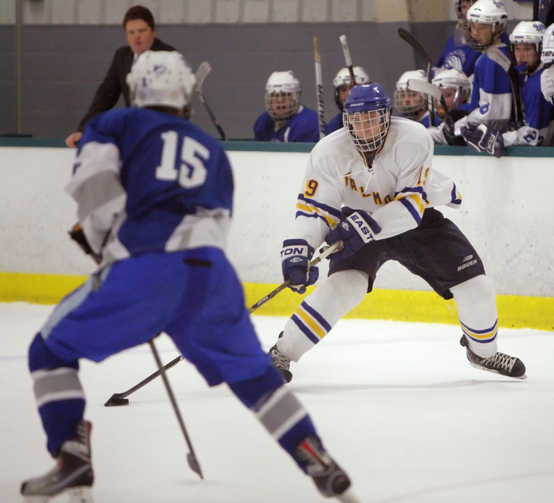 Ben Freeman of Falmouth looks for an opening past Cam Wiewel of Kennebunk during the first period of Falmouth’s 10-1 victory Tuesday night in a Western Class A quarterfinal.