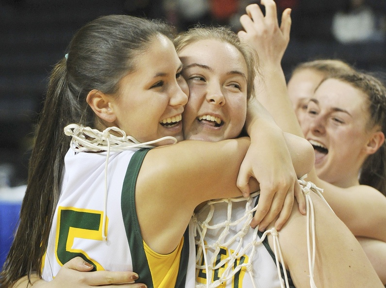 Mary Leasure, left, and Kate Liziewski, a co-captain, are seniors who didn’t play that much on McAuley’s talent-laden team this season, But when the time came to cut down the nets after the state final, their teammates insisted in a classy move that they do the honors. And they did it in style.