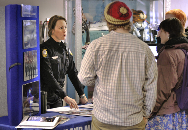 Officer Bethany Murphy discusses employment opportunities within the Portland Police Department during the job fair at PATHS this morning.