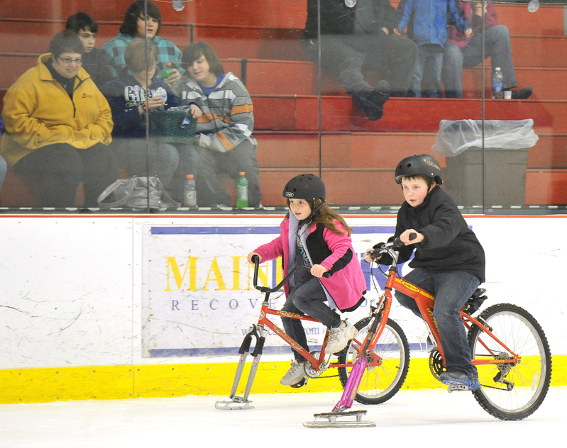 Briana Baillargeon, 8, races neck and neck with her brother, Jordan, 10. A Community Bicycle Center volunteer adapted bikes for the ice by adding some of his old skates.