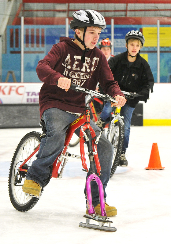 Will Rees and other ice bikers take the final turn in a race at the Biddeford Ice Arena on Saturday. The Bikes on Ice event gave kids involved with the Community Bicycle Center a different way to have fun while cycling.