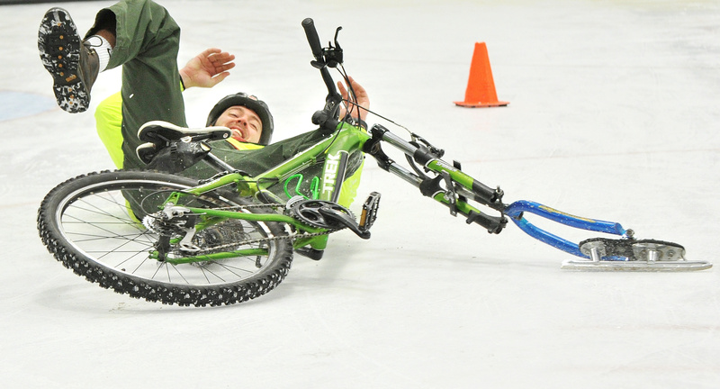 Andrew Burnell, program director at the Community Bicycle Center in Biddeford, takes a spill in the final turn of an ice race in the adult division on Saturday. Last year the center worked with 300 youths who built bicycles or went on bike trips.