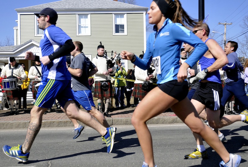 Runners make their way down Main Street in Saco past the Claddagh Mhor Pipe Band during Mary's Walk and the Kerrymen Pub 5K road race on Sunday.