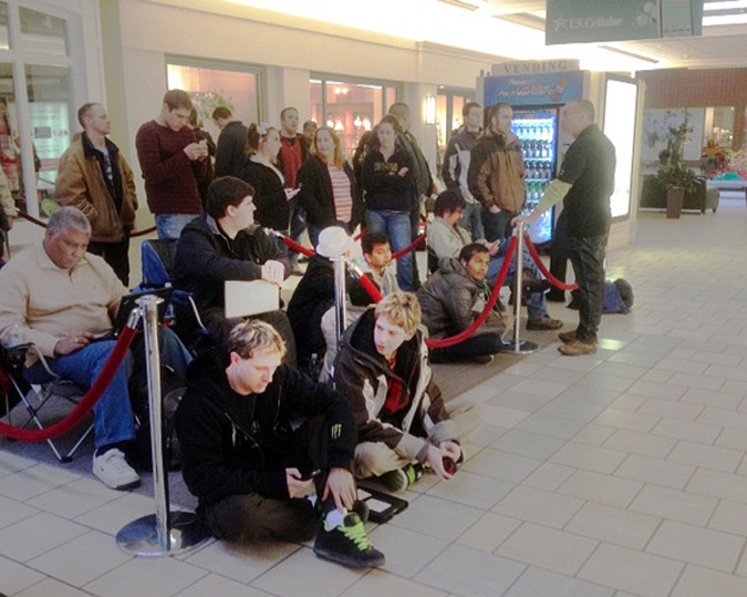 About 50 people wait in line at the Apple Store at the Maine Mall in South Portland this morning to purchase Apple's new iPad. The store opened at 8 a.m. for the special event.