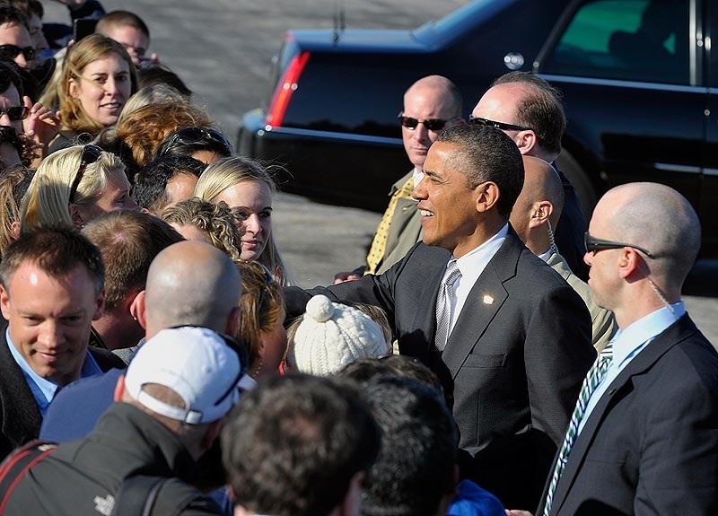 President Obama arrives on Air Force One at Portland Jetport on Friday and shakes hands with VIPs and their families.
