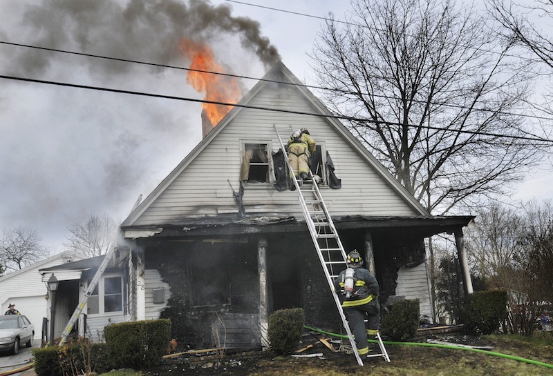 Firefighters battles the fire at 28 Raymond St. in Biddeford on Saturday morning March 31, 2012.